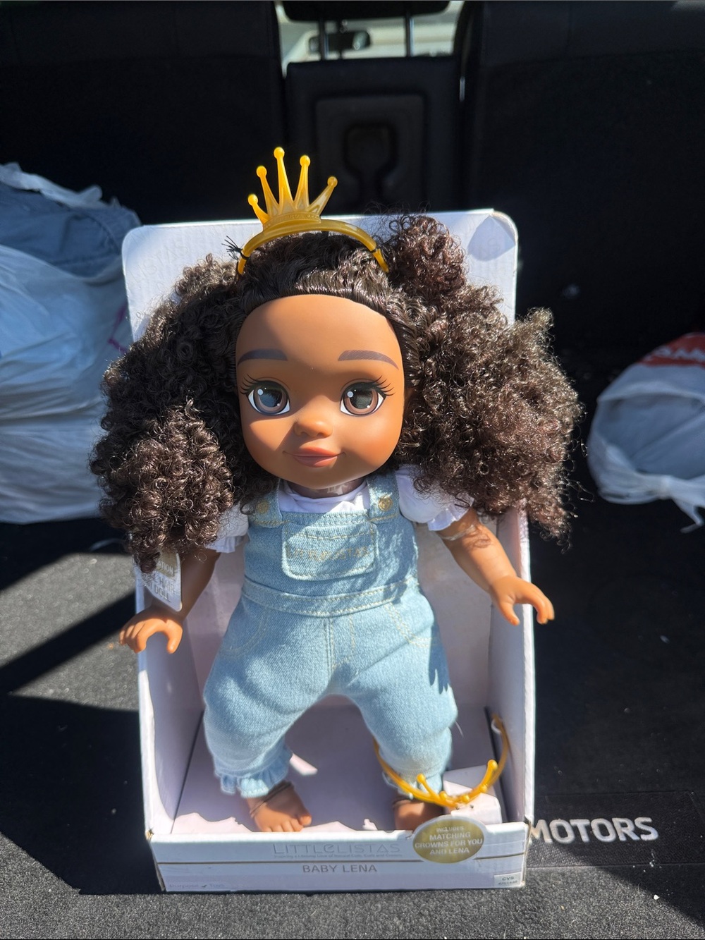 Curly-Haired Baby Doll with Yellow Crown and Light Blue Overalls